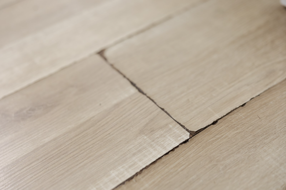 closeup of water damaged laminate flooring